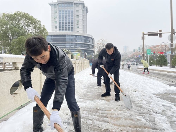 党员志愿者参加冬季扫雪除冰行动。邗江烟草供图