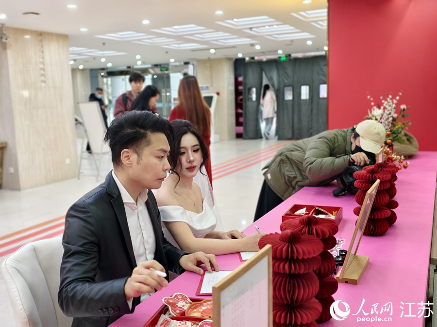 鼓楼区婚姻登记处在热门商圈设置打卡点，新人带专业摄影师拍照留念。人民网记者 马晓波摄
