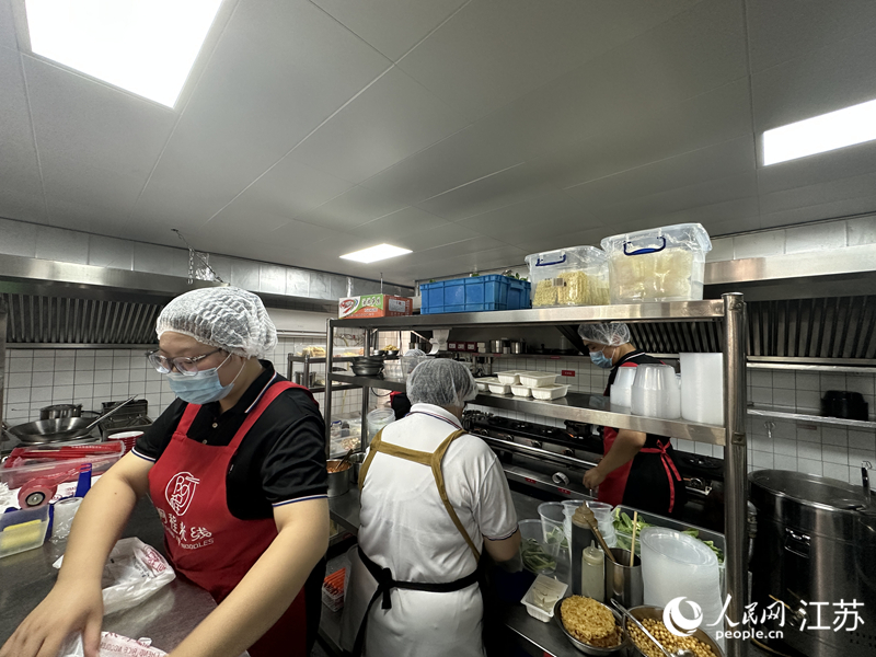“阿程米线”南通学士府店，后厨在忙碌。人民网 赵登岩摄