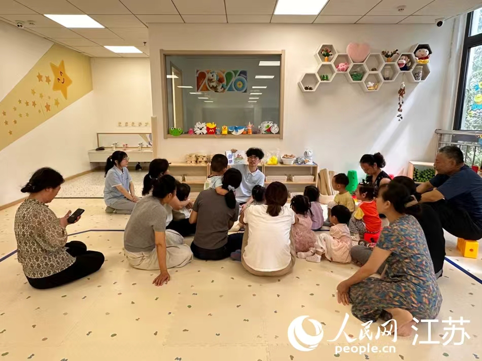 “西城·晨星托育”托育点，老师为孩子们讲述绘本故事。人民网 王纯摄