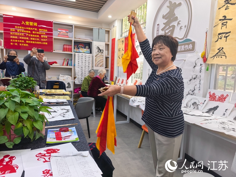 光明小区居民胡元美表演打快板。人民网记者 张玉峰摄